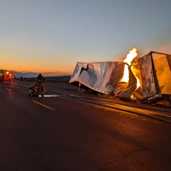 National Park Service firefighters work on the burning truck.