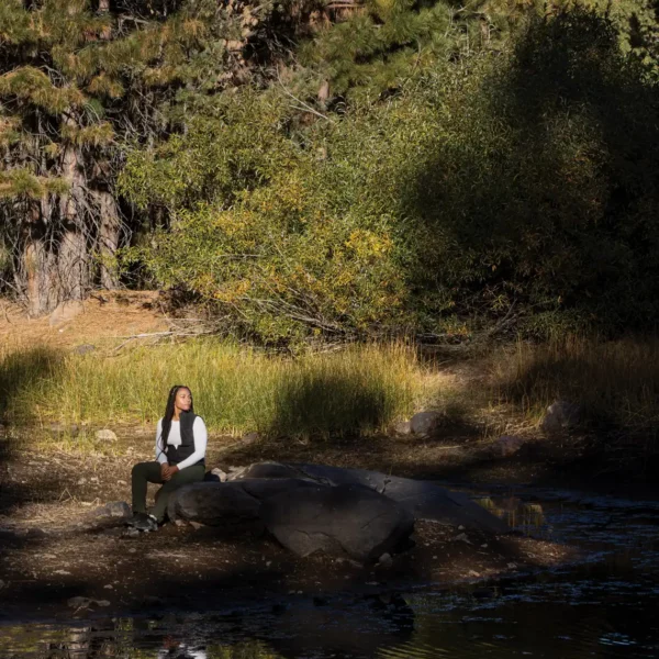 Jade Stevens rests near Lake Putt on land in California’s Tahoe National Forest that is owned and managed by the 40 Acre Conservation League.