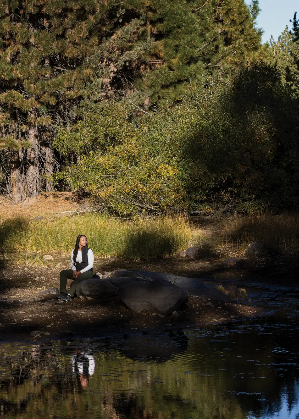 Jade Stevens rests near Lake Putt on land in California’s Tahoe National Forest that is owned and managed by the 40 Acre Conservation League.